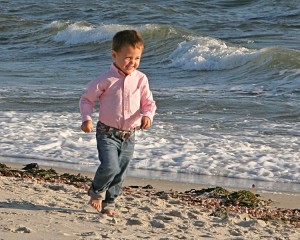 A little boy photographed having fun on a Cape Cod beach