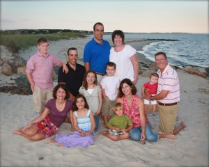 A family wearing a wide variety of colors for their family portrait.