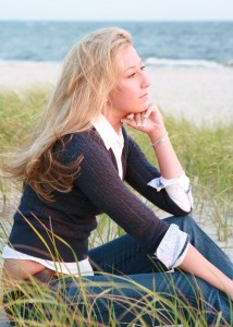 Picture of a high school senior sitting on a Cape Cod beach