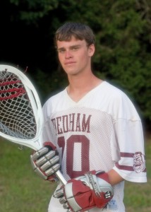 A picture of a high school senior holding a lacrosse stick